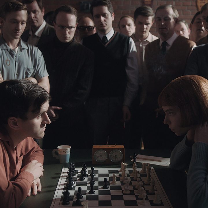 Two people play chess in The Queen's Gambit on Netflix.