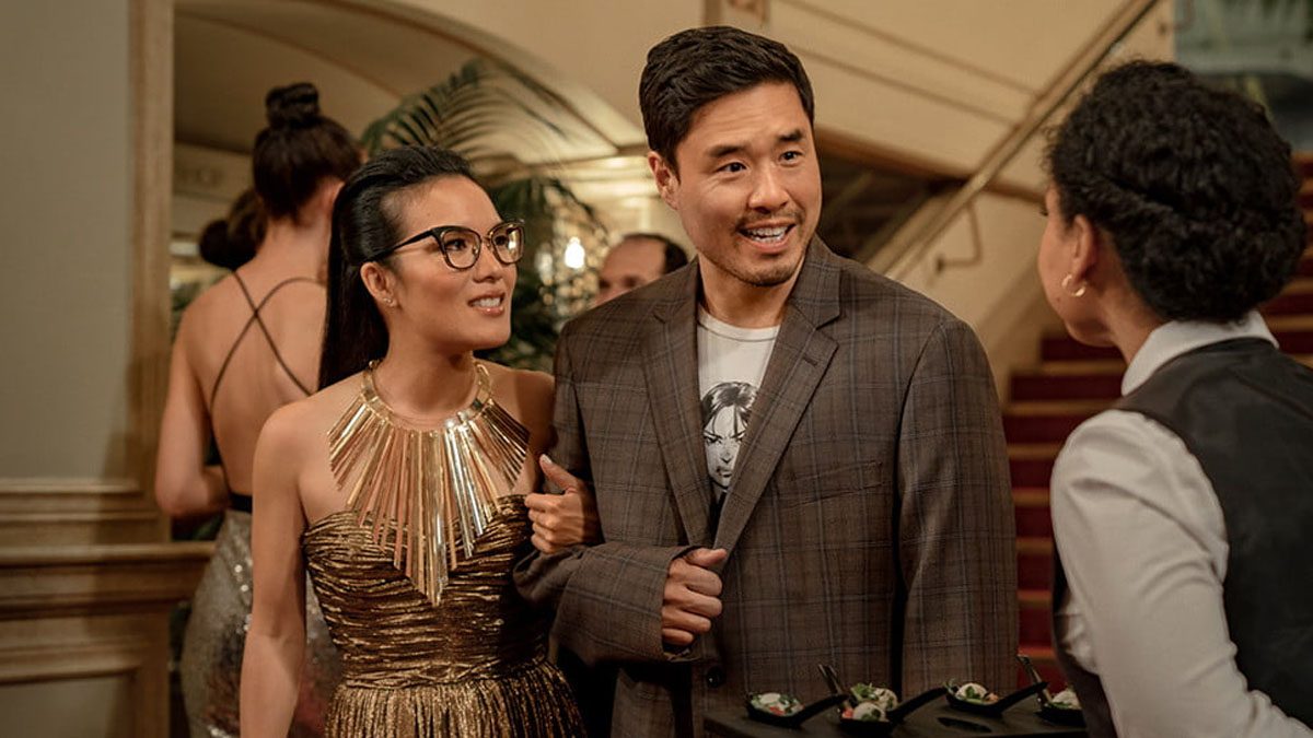 Ali Wong and Randall Park stan arm-in-arm in a scene from Always Be My Maybe.