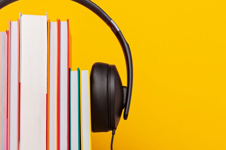 Headphones on a stack of books.