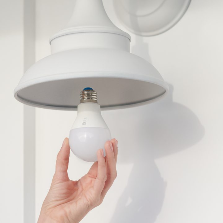 Ring Smart Bulb being installed in light fixture.