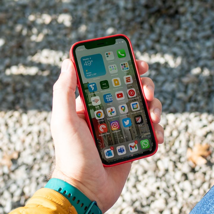 A hand holds the iPhone 12 Mini.