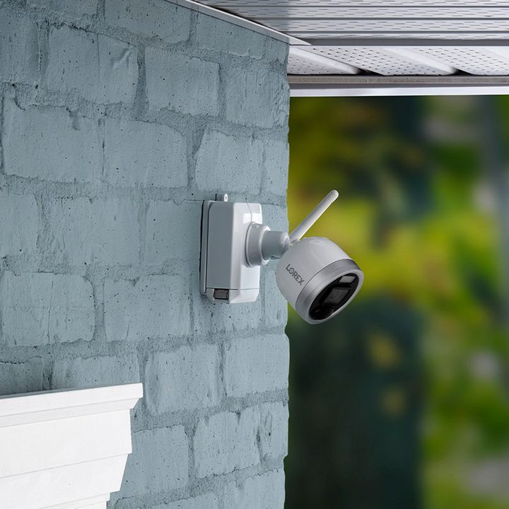 Lorex 1080p wire-free camera security system mounted on a brick wall.