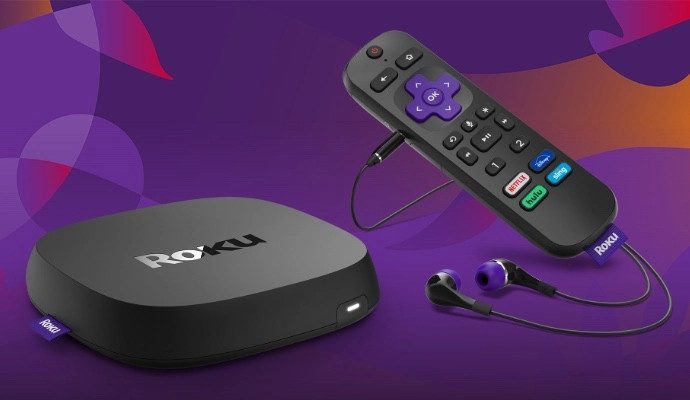 The Roku Ultra is shown with its remote and headphones plugged in.