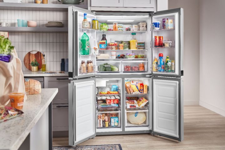 Whirlpool fridge in kitchen with door open.