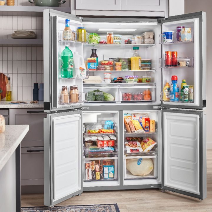 Whirlpool fridge in kitchen with door open.