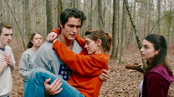 A guy carrying a young girl through the woods in the movie Yes God Yes
