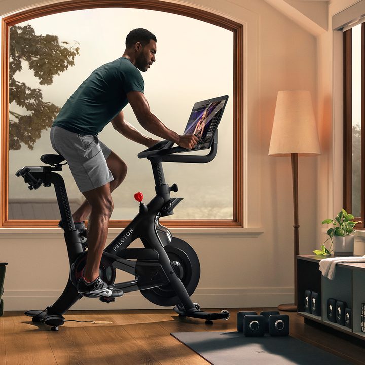 Man on a Peloton Bike Plus.