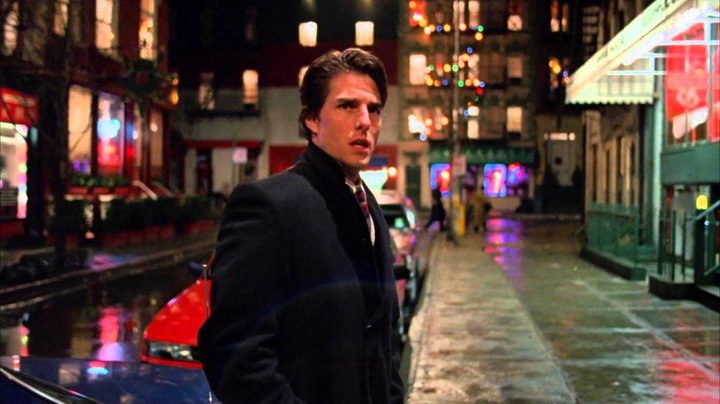 Tom Cruise as Bill Harford standing in a street at night in the film Eyes Wide Shut.