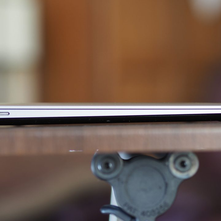 The Macbook Air M1 on a table with the lid down, showing both USB-C ports.