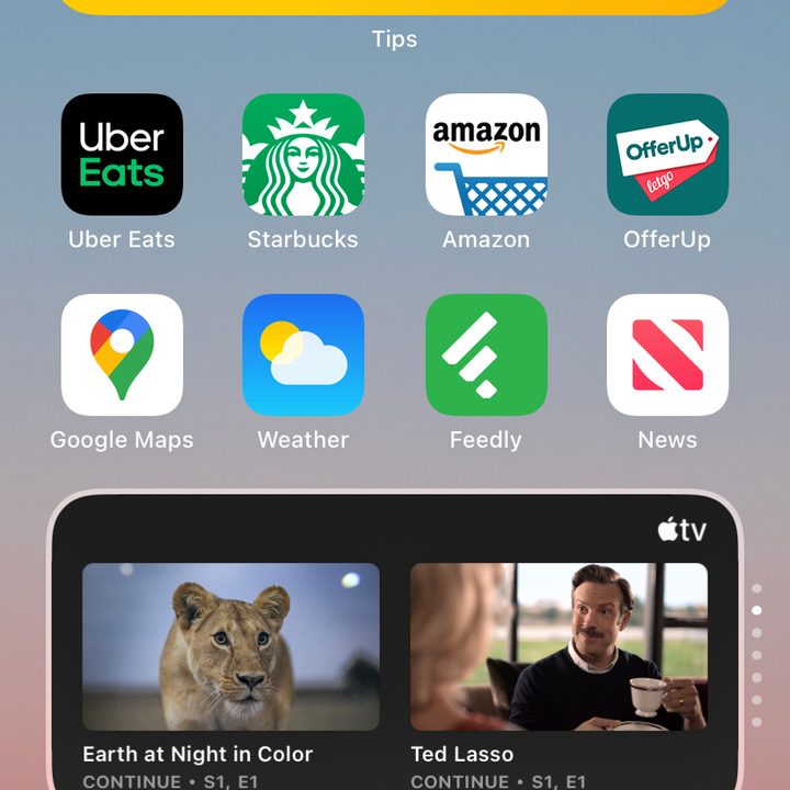iPhone home screen with showing Smart Stack widget switching between widgets.