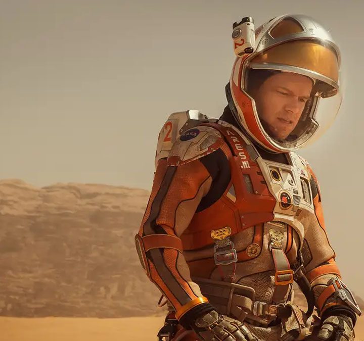 Matt Damon stands in his spacesuit on Mars in The Martian.