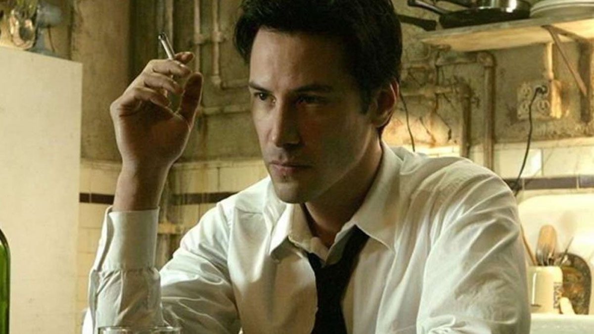 Keanu Reeves smokes a cigarette as John Constantine in a still from the movie Constantine.