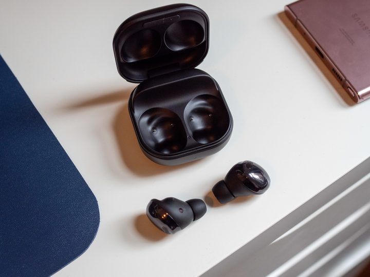 The Samsung Galaxy Buds Pro, sitting on a white table.