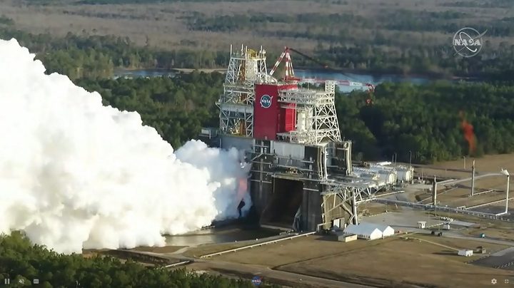 The core stage for the first flight of NASA’s Space Launch System rocket is seen in the B-2 Test Stand during a hot fire test Jan. 16, 2021, at NASA’s Stennis Space Center near Bay St. Louis, Mississippi.