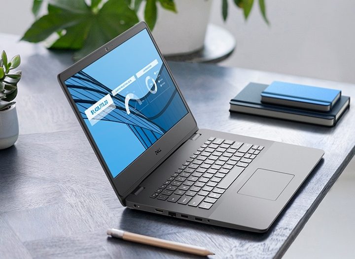 A Vostro 3400 laptop open on a table.