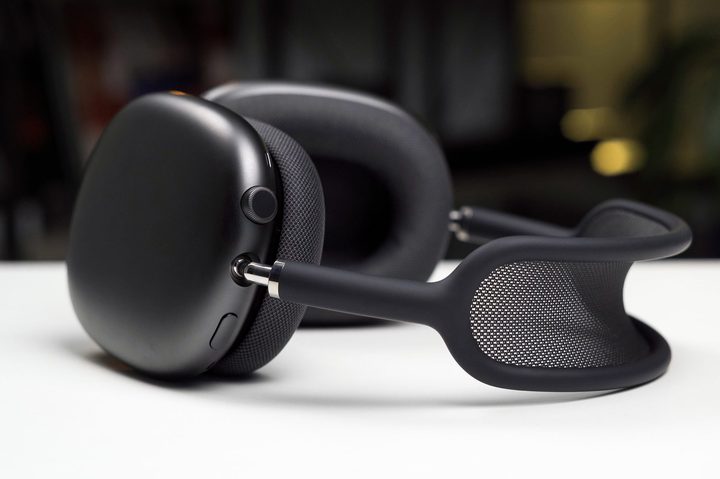 The Apple AirPods Max on a surface, viewed from the side.