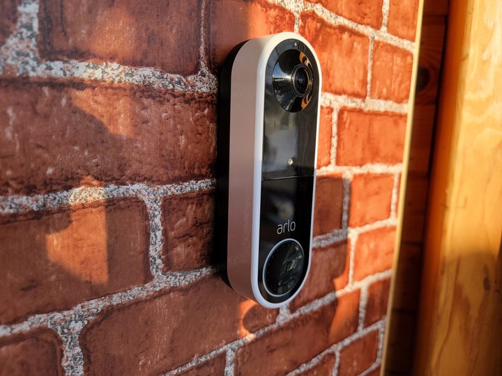 Arlo Essential Wireless Doorbell mounted on brick