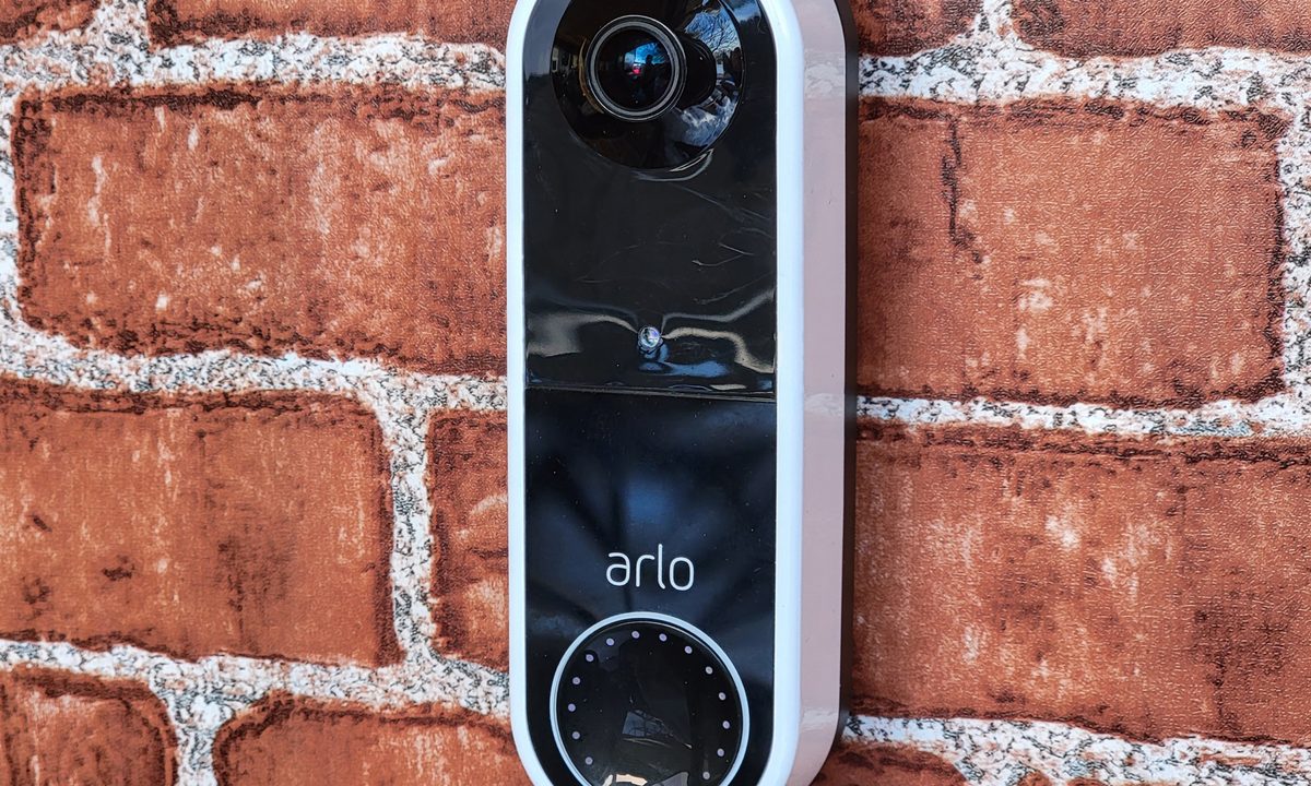 Arlo Essential Wireless Doorbell mounted on brick