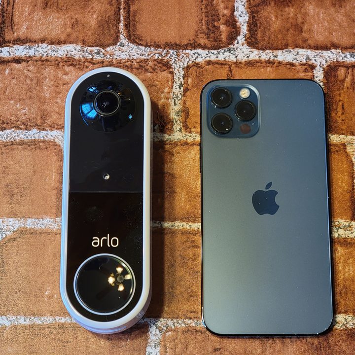 Size comparison between the Arlo Video Doorbell and an iPhone 12 Pro