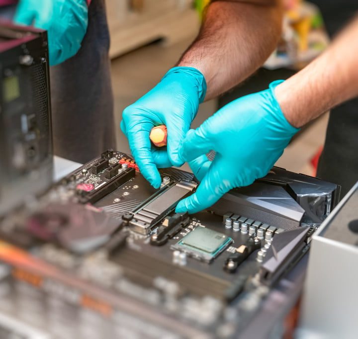 Someone mounting an SSD inside a PC.