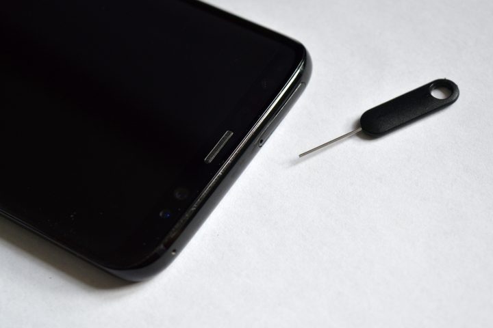 Image of a Galaxy S8's MicroSD card slot with a PIN tool nearby