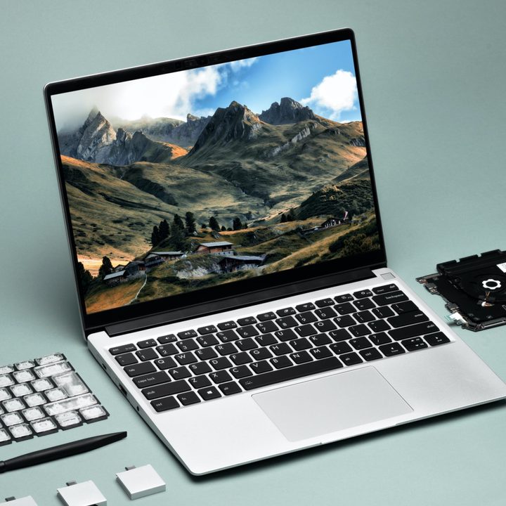 Framework Laptop with components sitting nearby.
