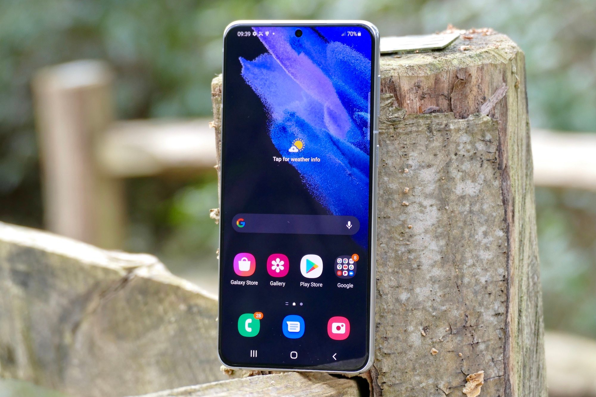 The Samsung Galaxy S21 Plus leaning on a surface.