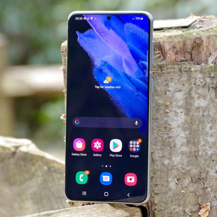 The Samsung Galaxy S21 Plus leaning on a surface.