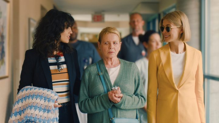 Eiza González, Diane Wiest, and Rosamund Pike as Fran, Jennifer, and Marla walking together down a hallway in I Care A Lot.