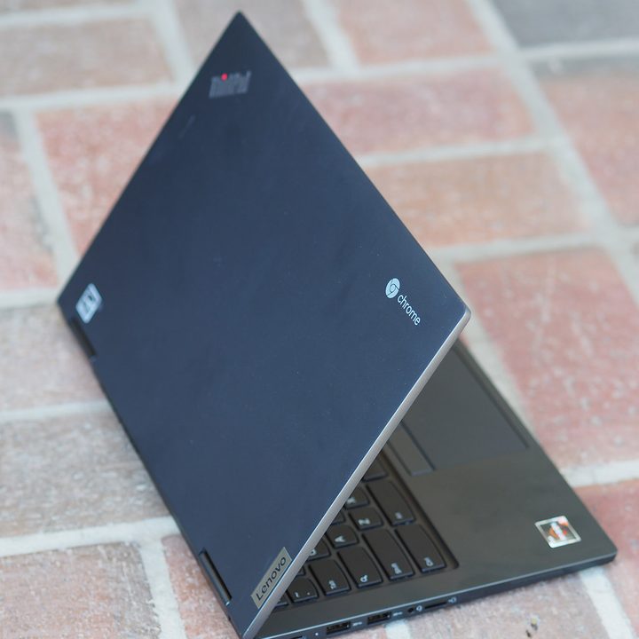 A Lenovo Chromebook on a brick floor.