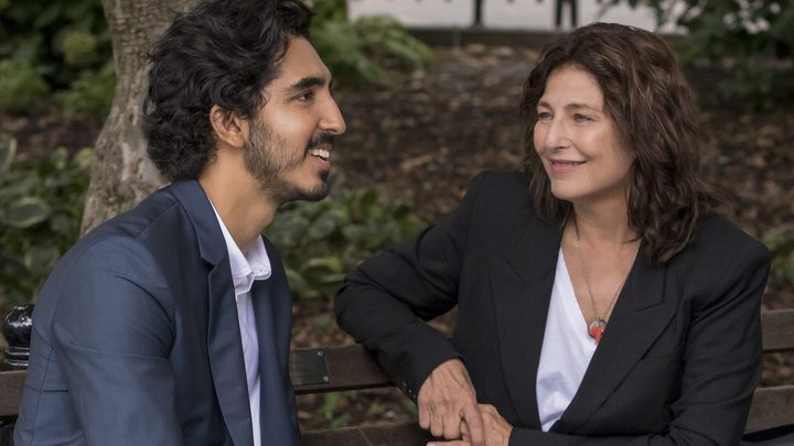A man and a woman sit on a bench with each other.