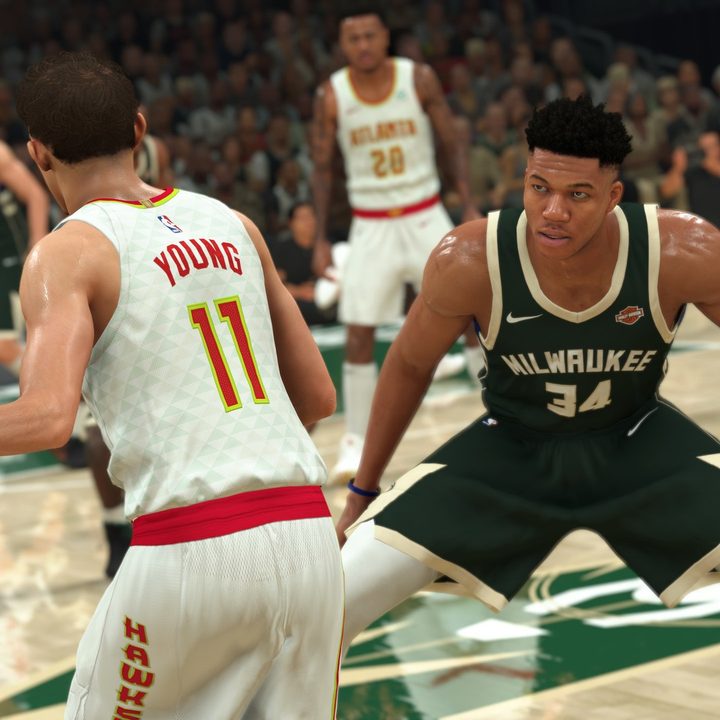 Two basketball players playing basketball.