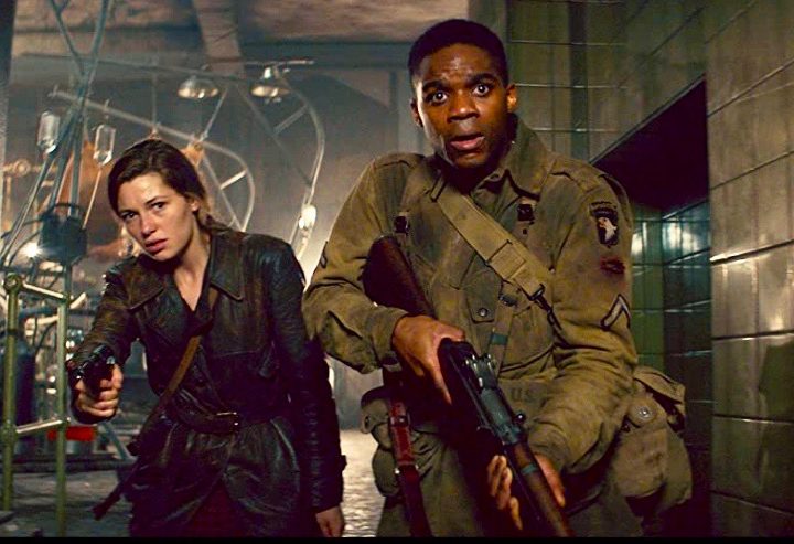 Two characters with guns look fearful as they encounter horror in Overlord.