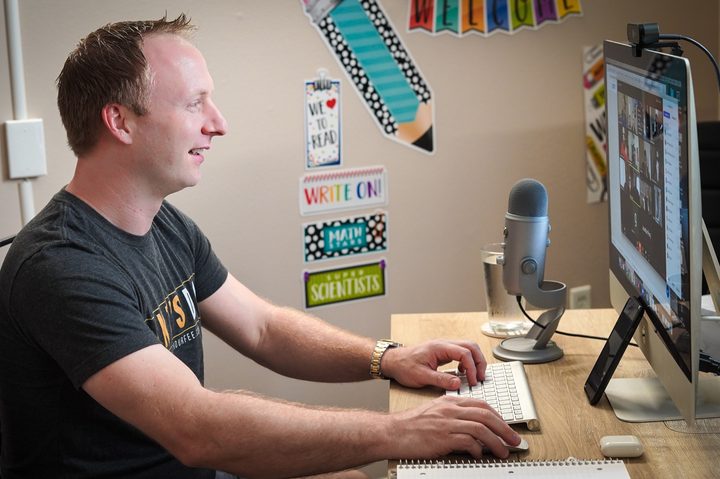 Man using iMac computer with webcam