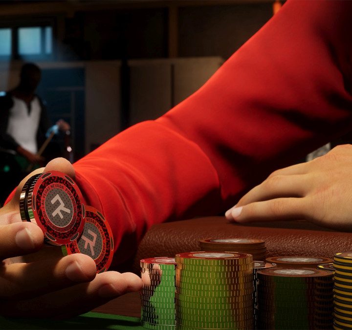 A man in a red hoodie holding poker chips.