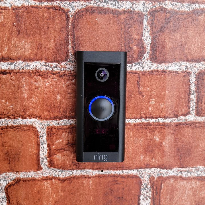 Ring Video Doorbell Wired mounted on a brick wall.