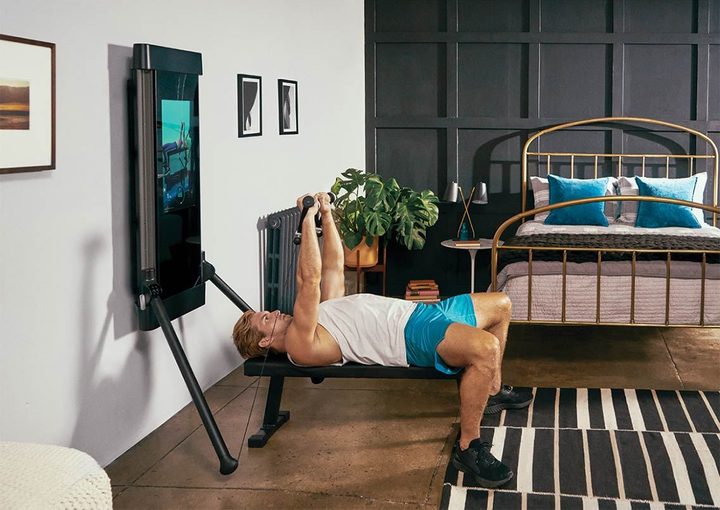 A person lifting weights with Tonal
