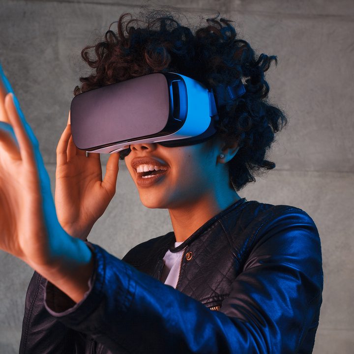A woman reaching out while wearing a VR headset.