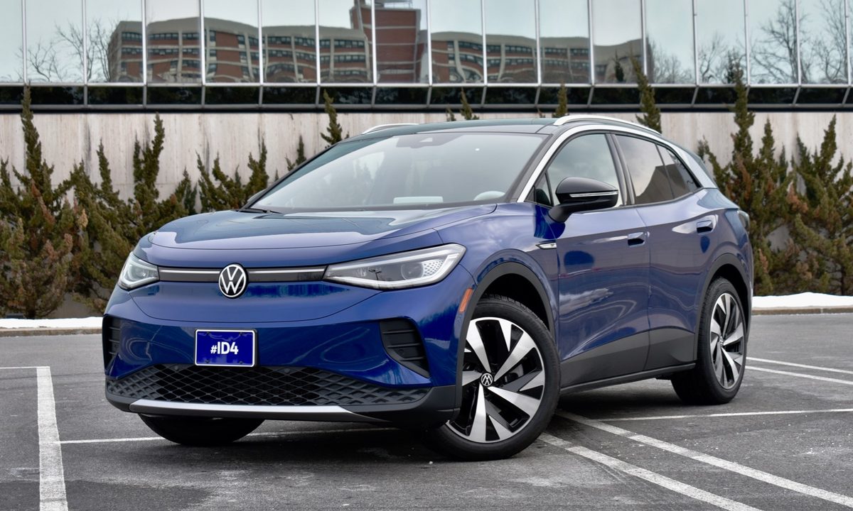 A blue 2021 Volkswagen ID.4 is parked diagonally in a parking lot.