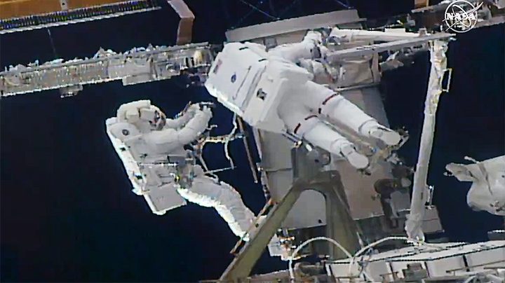 (From left) Astronauts Soichi Noguchi and Kate Rubins work to install a solar array modification kit during the fourth spacewalk of 2021.