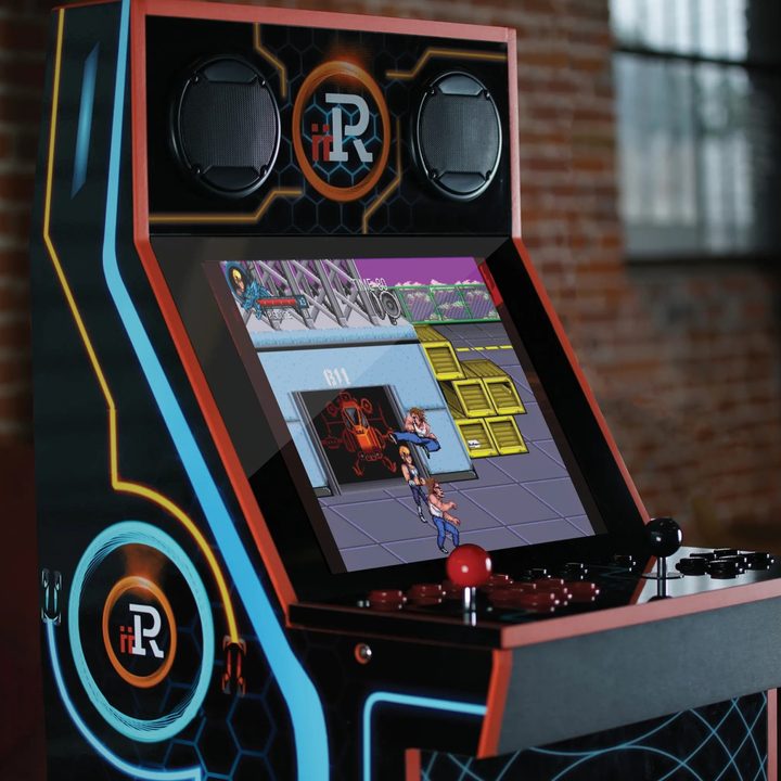 An iiRcade arcade cabinet standing against a brick wall.