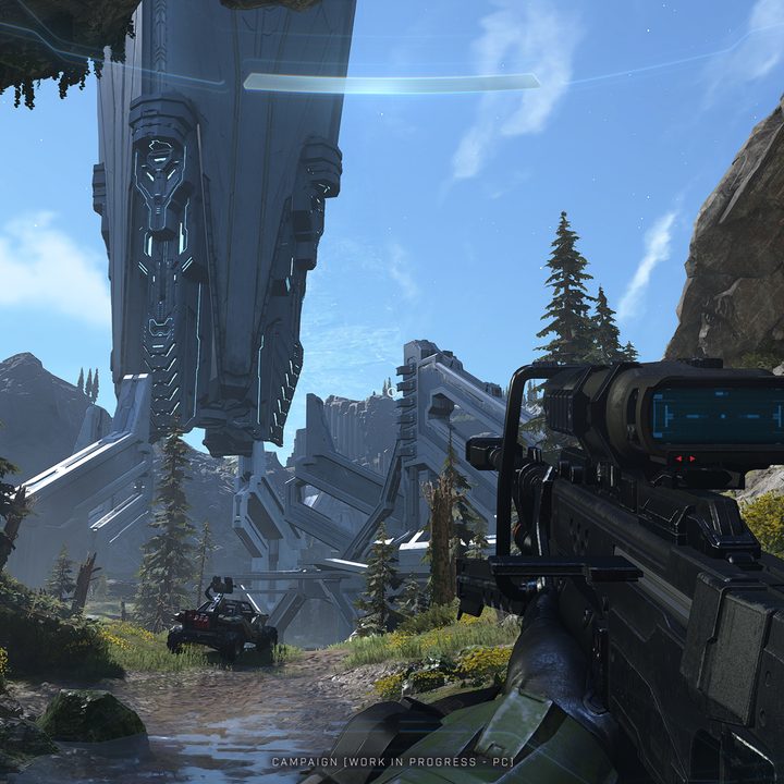 Master chief holding a sniper approaching a giant building.