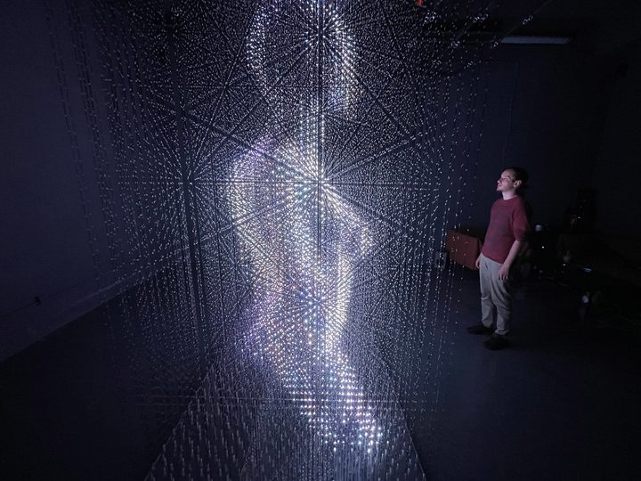 Man looking at LED Pulse volumetric display