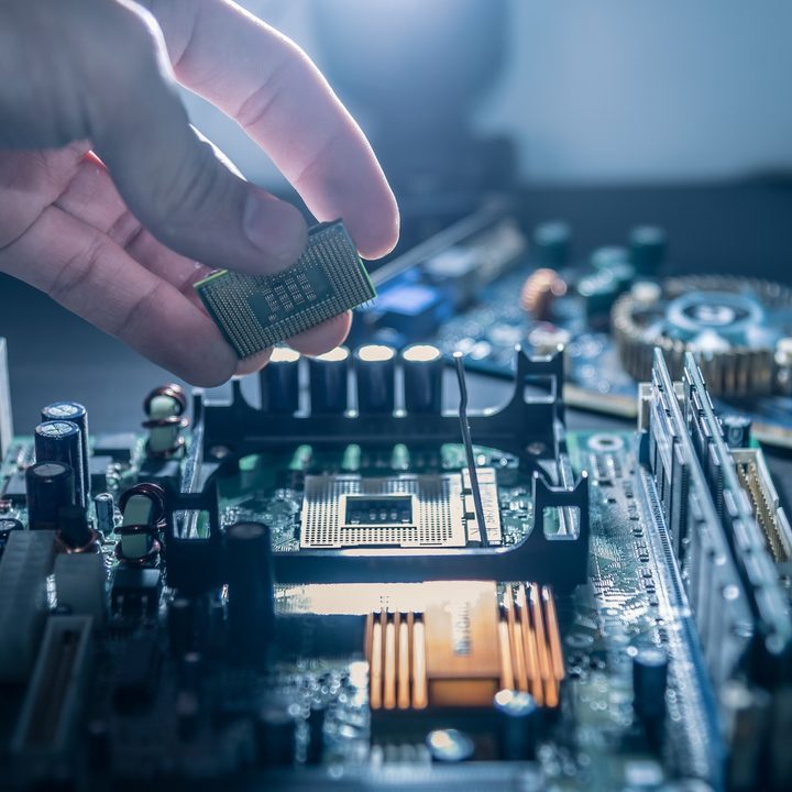 Someone placing a processor in a motherboard.