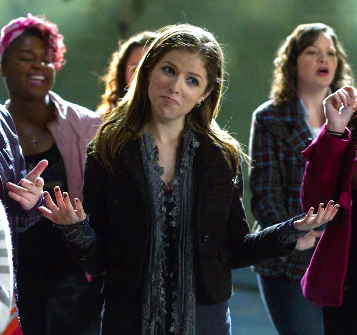 A group of girls stand next to each other in pitch perfect.