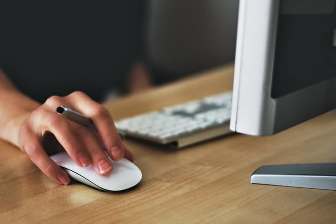 Apple Magic Mouse on a desk.