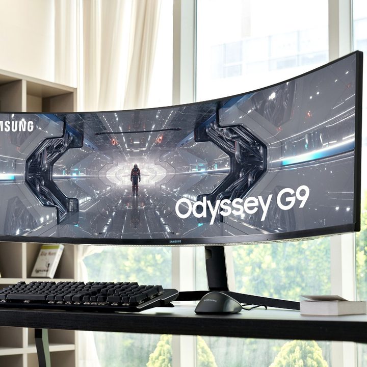 The Samsung Odyssey G9 monitor on a desk in an apartment.