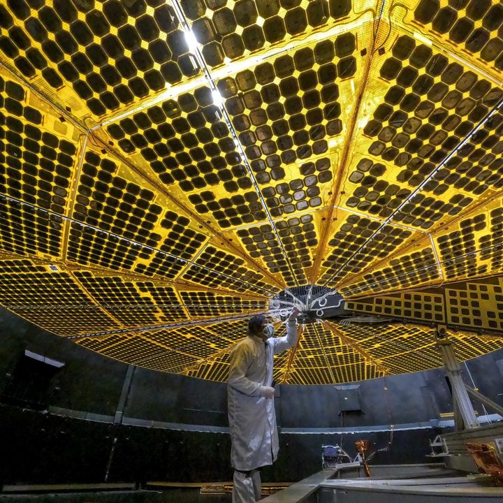 At 24 feet (7.3 meters) across each, Lucy&rsquo;s two solar panels underwent initial deployment tests in January 2021. In this photo, a technician at Lockheed Martin Space in Denver, Colorado, inspects one of Lucy&rsquo;s arrays during its first deployment. These massive solar arrays will power the Lucy spacecraft throughout its entire 4-billion-mile, 12-year journey through space as it heads out to explore Jupiter&rsquo;s elusive Trojan asteroids