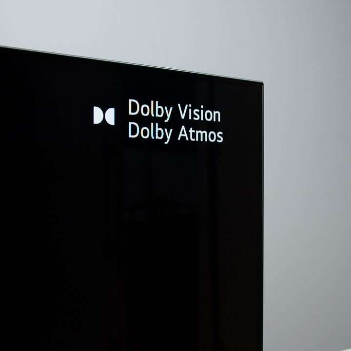 An LG C1 OLED 4K TV displaying Dolby Vision and Dolby Atmos logos.