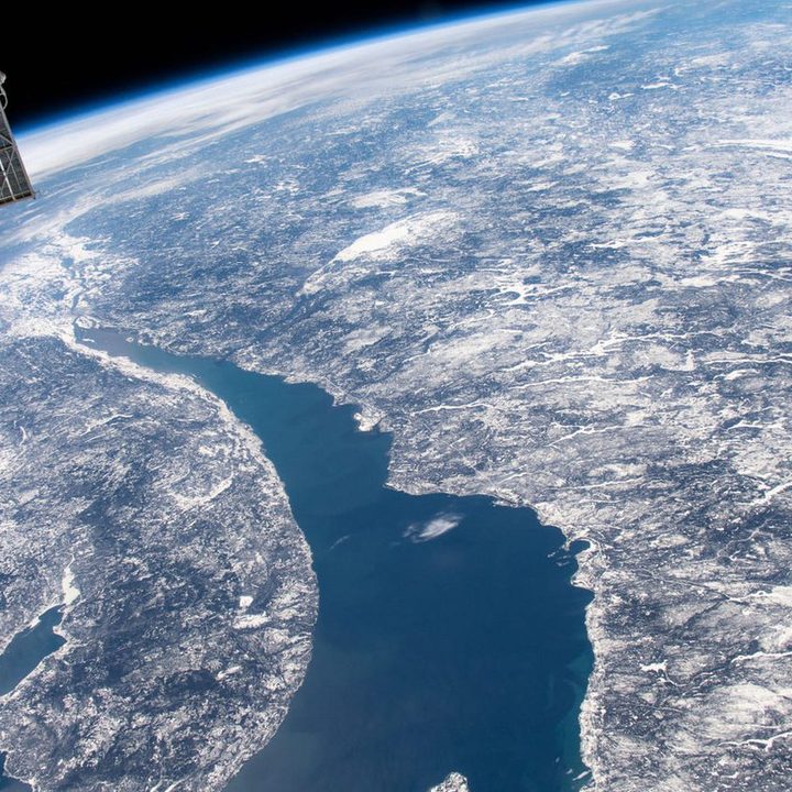 This image was captured by the International Space Station Expedition 59 crew as they orbited 400 kilometers above Quebec, Canada. Right of center, the ring-shaped lake is a modern reservoir within the eroded remnant of an ancient 100 kilometer diameter impact crater, which is over 200 million years old.